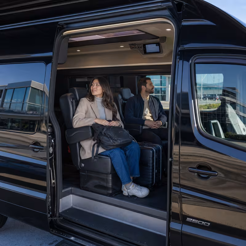 Passengers loading luggage while boarding an Sunnyvale group shuttle