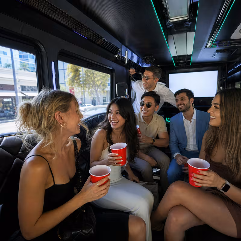 Party bus interior with wraparound leather seating and LED lighting in Sunnyvale