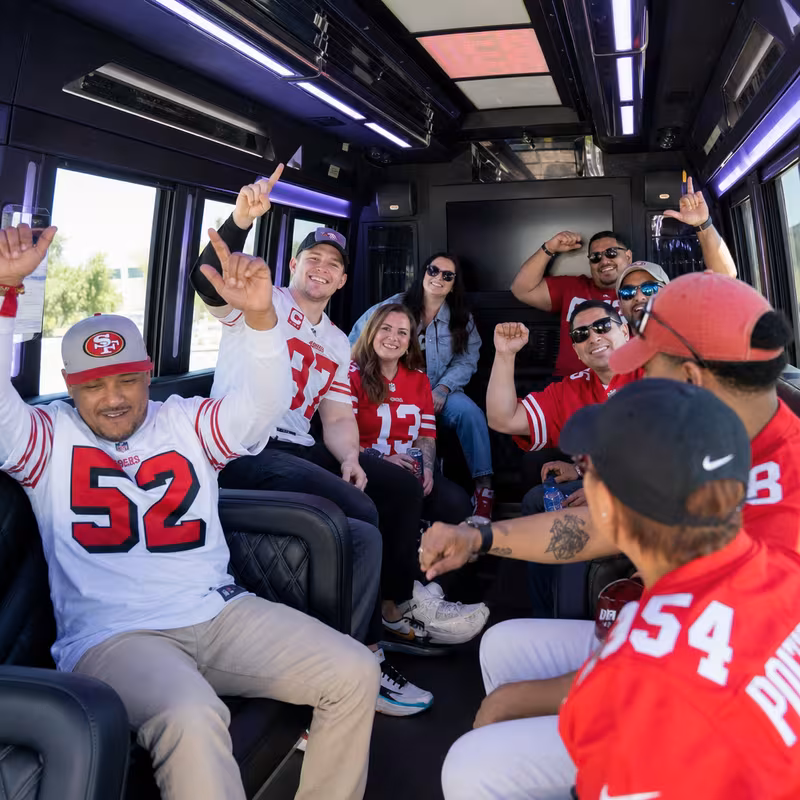 Group boarding a white charter bus for Sporting Event Transportation transportation in Sunnyvale