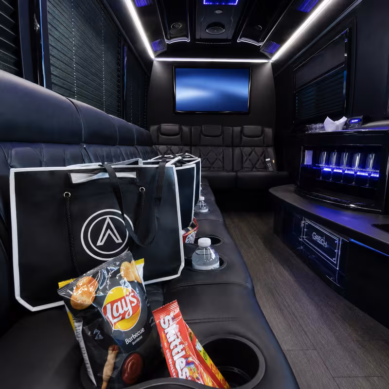 Party bus interior with wraparound leather seating and LED lighting in Sunnyvale